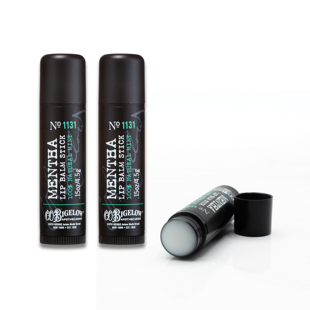 C.O. Bigelow Mentha Lip Balm sits at a desk, ready for hydration in a bag or on the go.