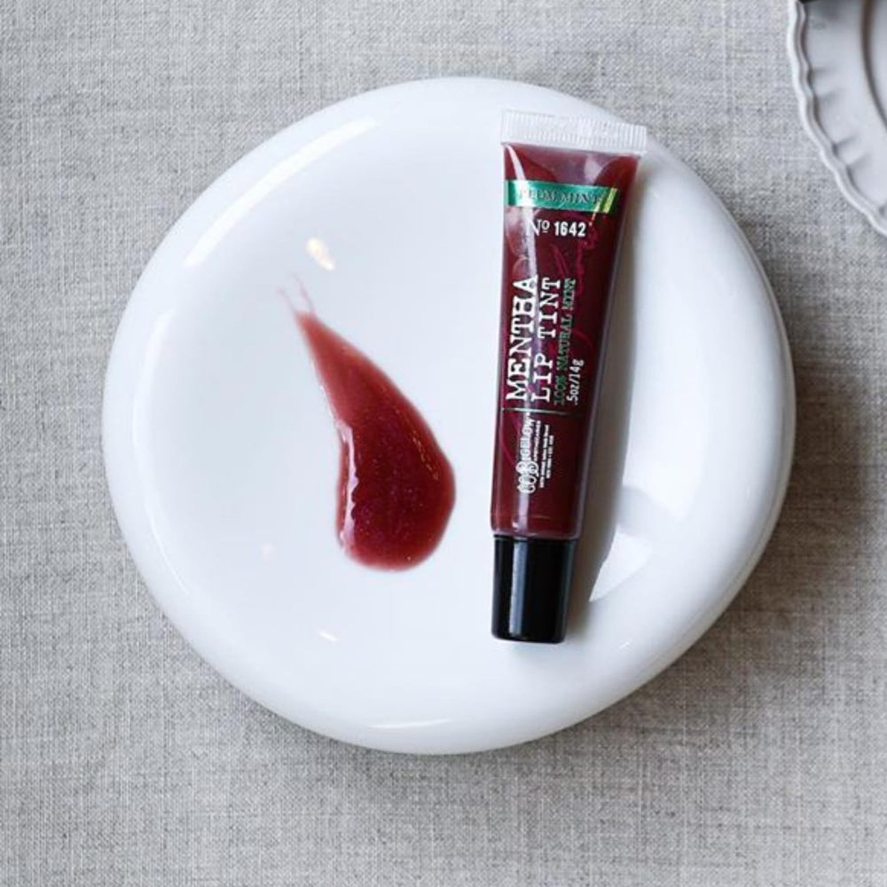 Glossy texture swatch shows sheer plum tint from Plum Mentha Lip Tint Trio.