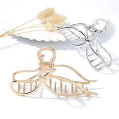 CAKURE Bow Hair Claw Clip gold worn for daily styling with no-slip hold.