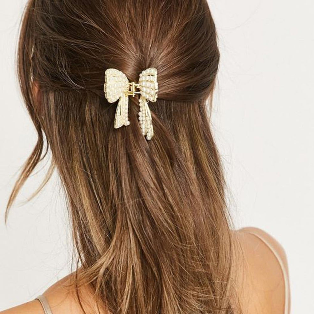 CAKURE pearl bow hair accessory on model demonstrates elegant day-to-evening styling.