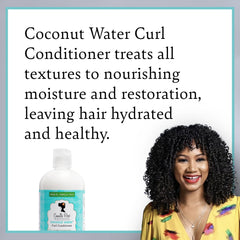 Applying Camille Rose Coconut Water Curl Conditioner to wet curls for detangling ease.