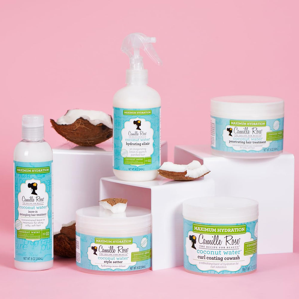 Ingredients shot featuring rosemary and castor oils in Camille Rose Coconut Water Curl Conditioner.