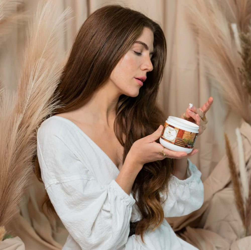 Camille Beckman glycerine hand therapy cream bottle on shelf emphasizes long-lasting hydration.