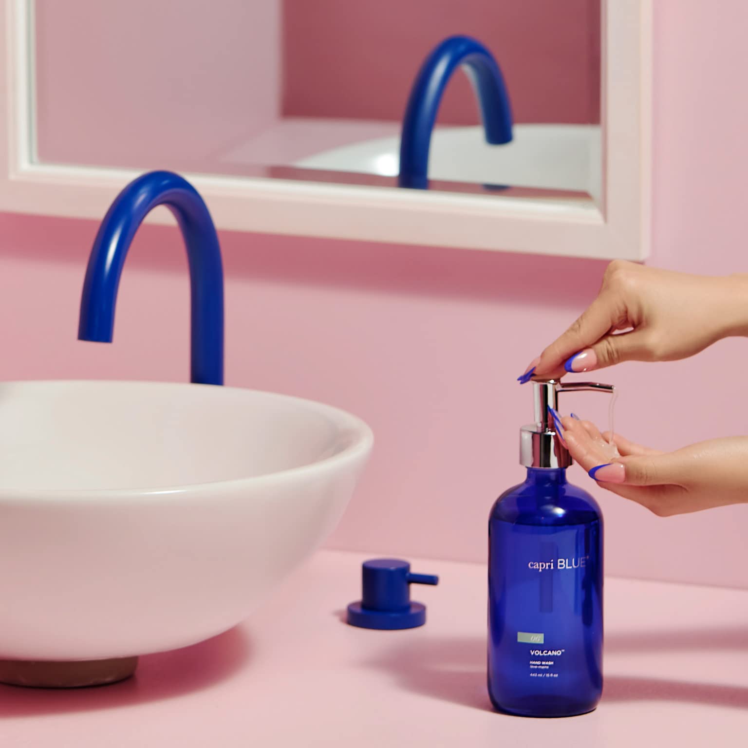 Capri Blue Volcano liquid hand wash being poured from a refillable bottle for daily moisture