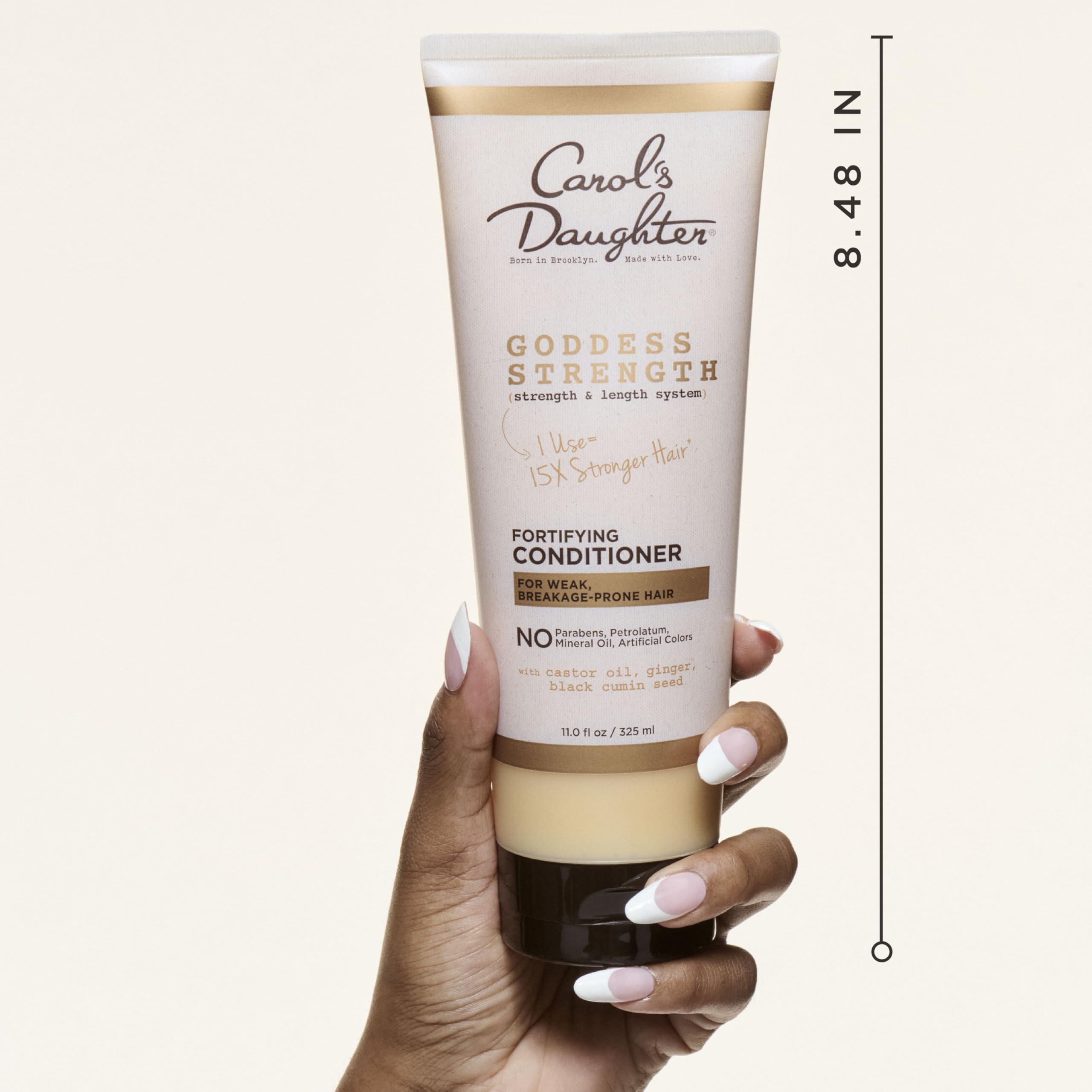 Carol's Daughter Goddess Strength application hands demonstrating easy distribution and detangling prep.