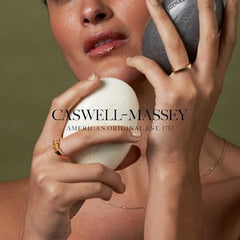 Caswell-Massey Lavender Bar Soap bar resting beside towels, ideal for daily cleansing.