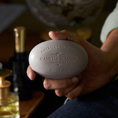 Caswell-Massey LX48 bar soap in hand demonstrates moisturizing feel for soft skin.