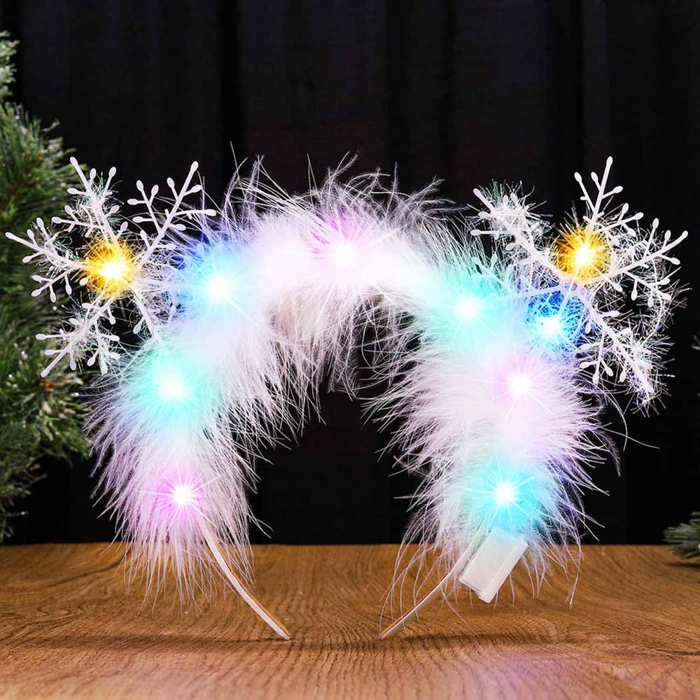 Catery snowflake ornaments and fluffy feathers adorn the headband for chic holiday vibes.