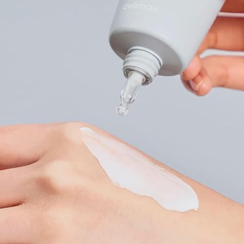 Celimax Dual Barrier Cream being applied on hand for smooth, moisturized skin.