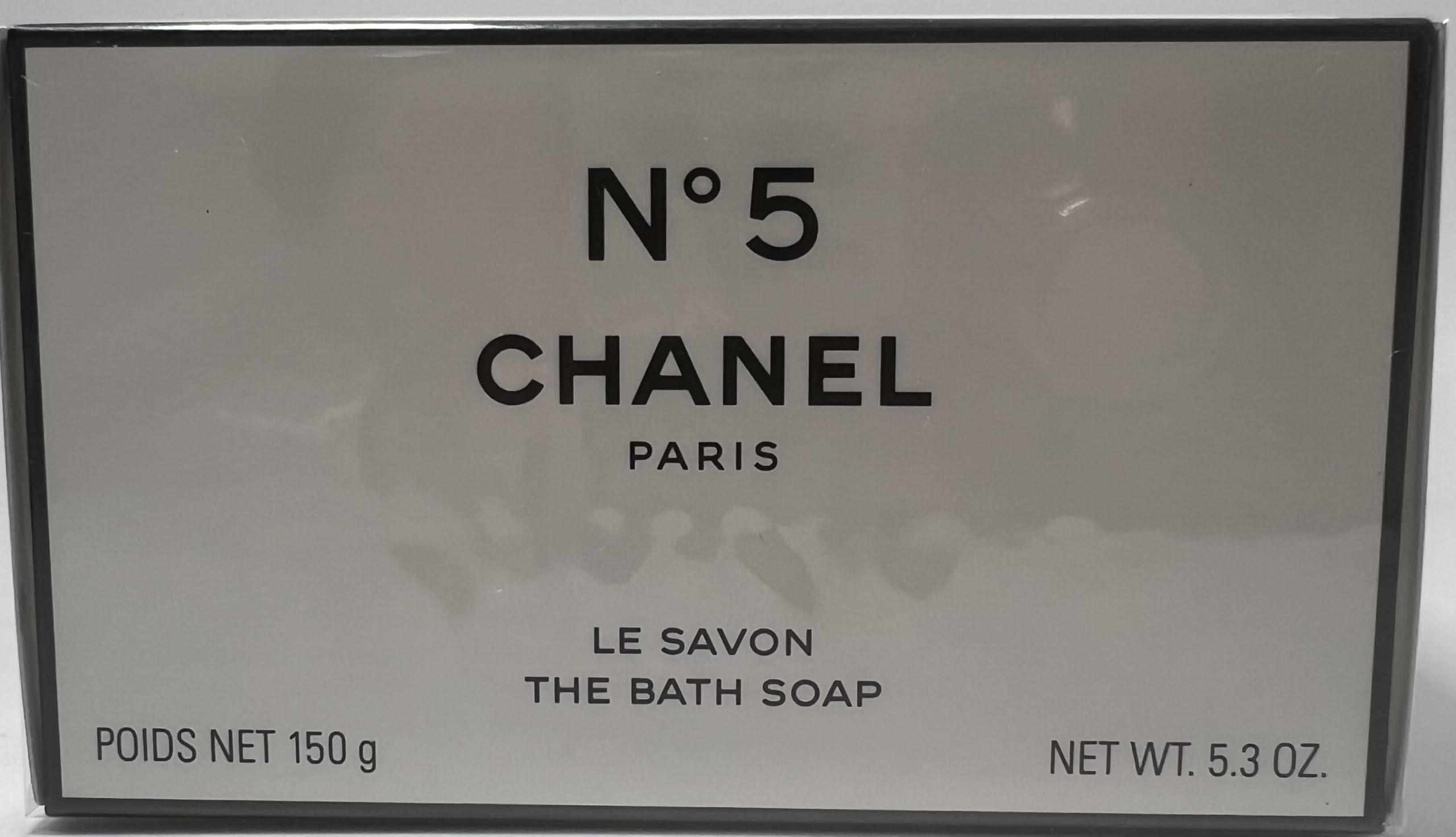 Chanel No 5 bath soap lather close-up reveals creamy foam for a pampering cleanse.
