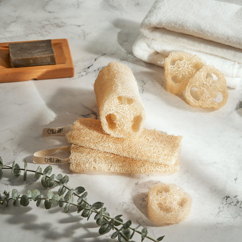 Chill Ah loofah sponge set handheld use showing skin-friendly exfoliation.