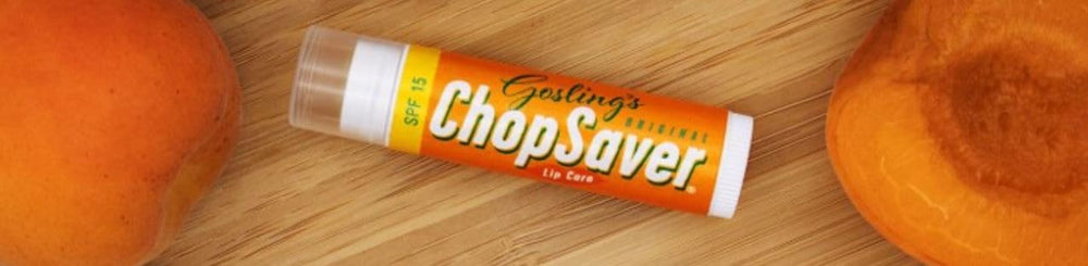 Hands apply ChopSaver lip balm, showcasing easy hydrating application.