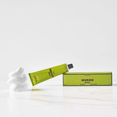 Claus Porto Musgo Real shaving cream being applied with a brush for rich coverage.