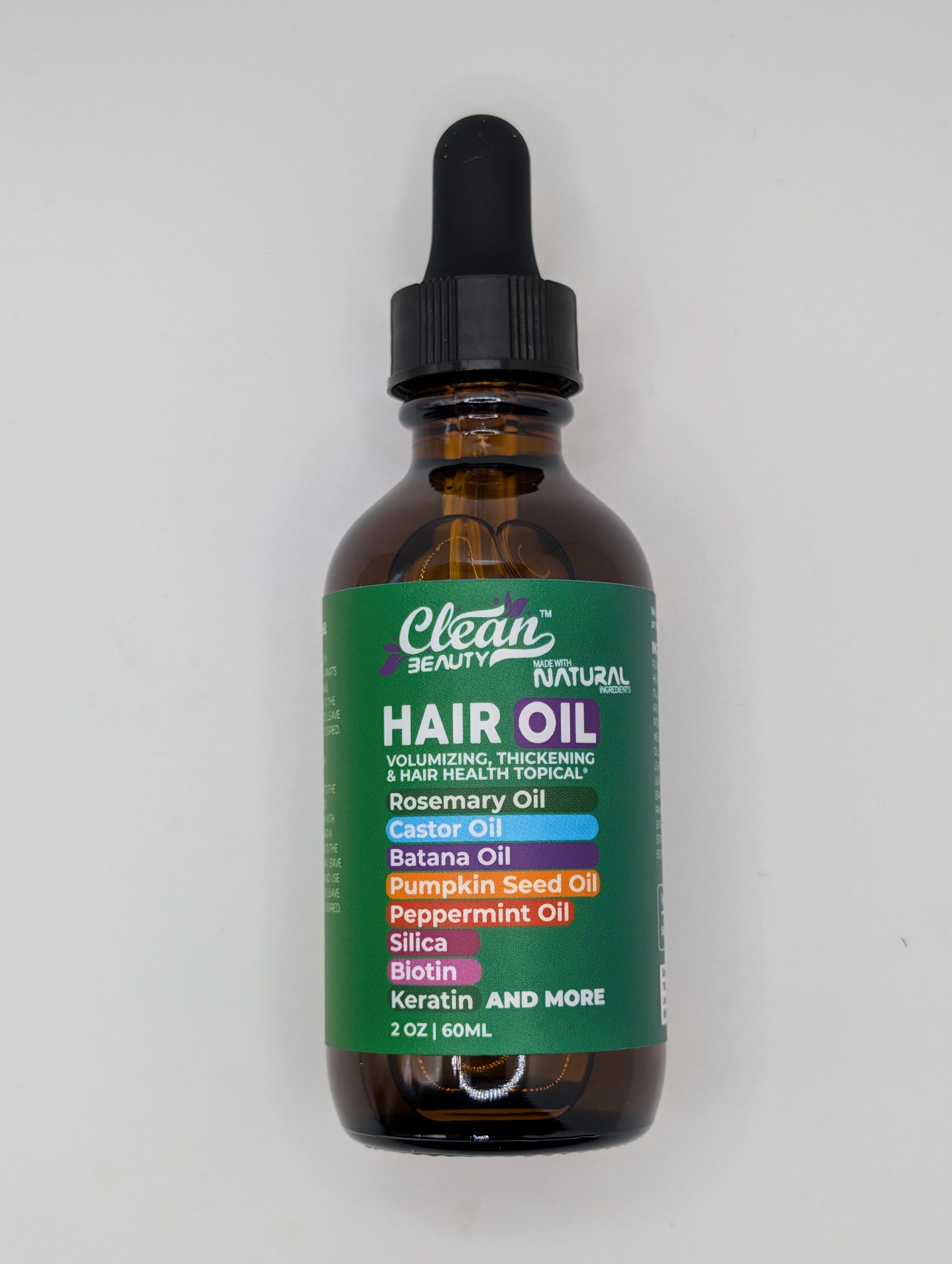 Clean Beauty Rosemary Hair Oil castor oil drop reflects scalp nourishment.