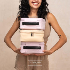 CLEAN SKIN CLUB Travel cosmetic bag in use with zipper securing makeup essentials