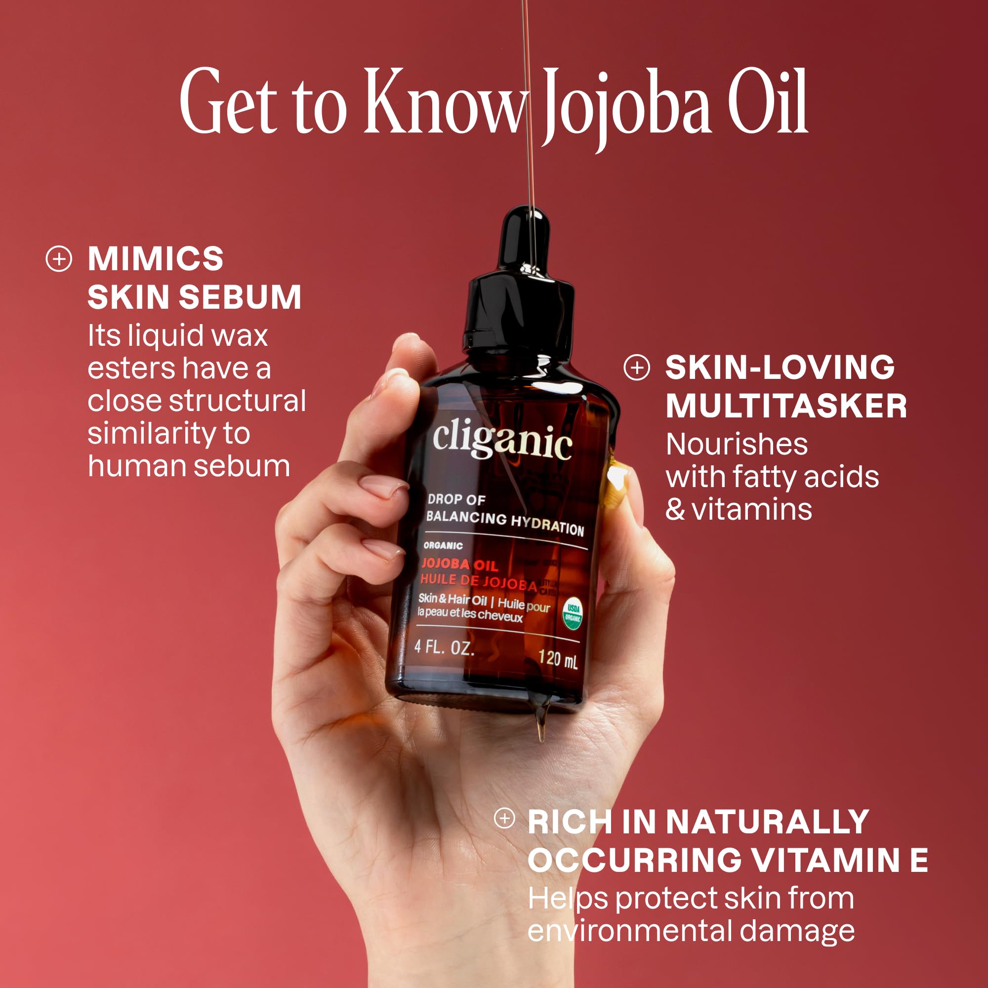 Cliganic Jojoba Oil clear drops on hand for skin nourishment.