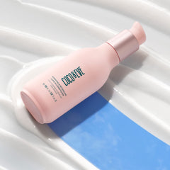 Coco & Eve leave-in conditioner bottle pour shows easy detangling.