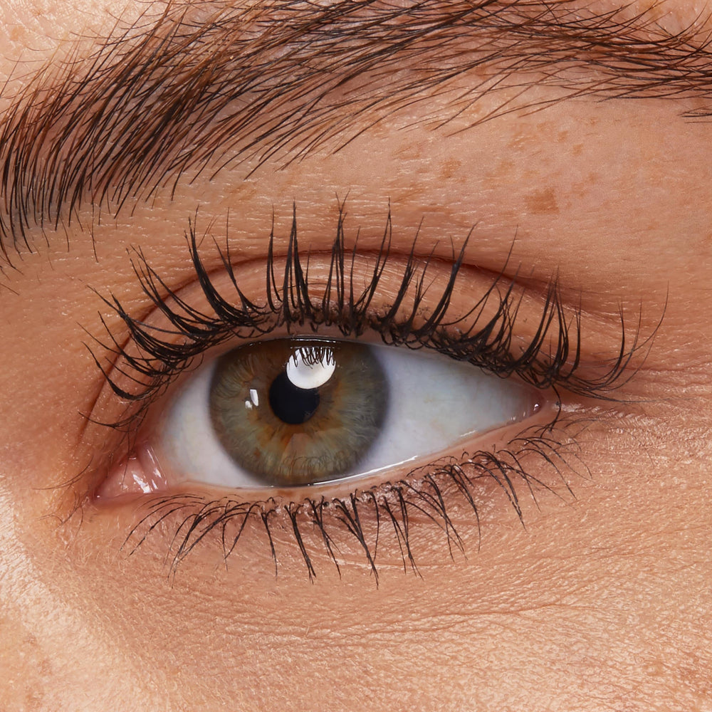 ColourPop Act Natural Defining Mascara applicator in use on lashes.