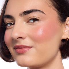 ColourPop Shrek tint swatch on cheeks demonstrates lasting moisture and sheen.