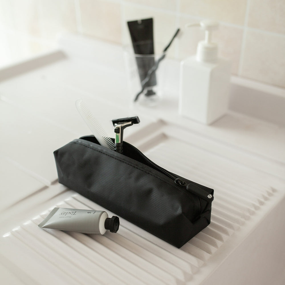 Comfyable Small Toiletry Bag uses water-resistant fabric to protect contents during spills and rain