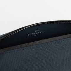 Comfyable blue toiletry bag collapsed flat for space saving storage.