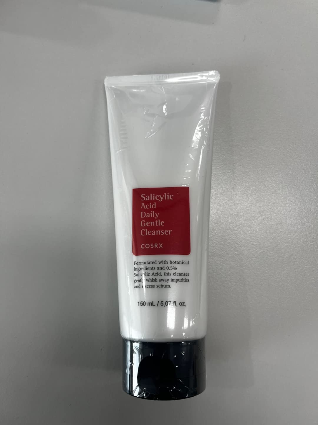 COSRX cleanser being applied to damp skin in routine