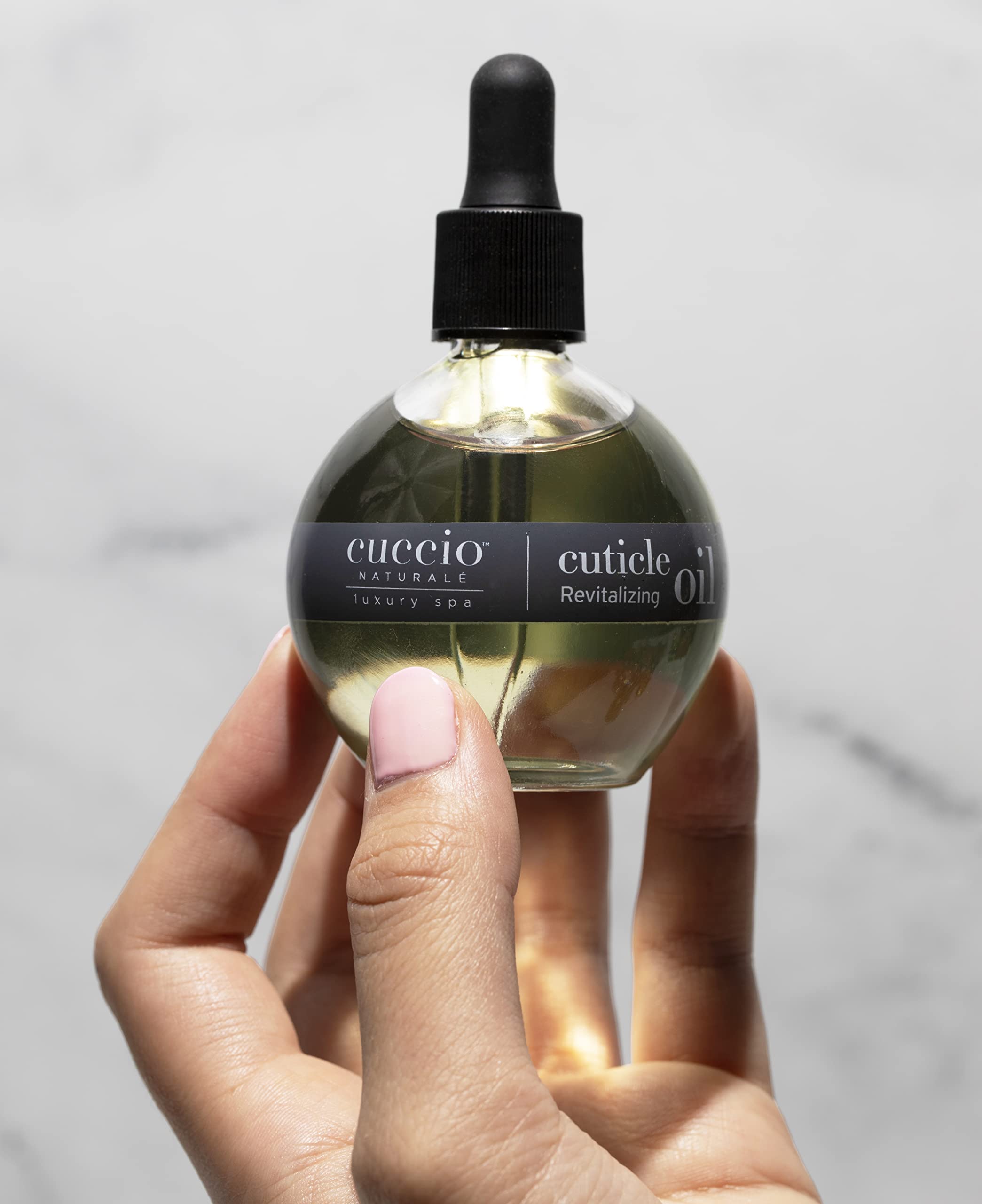 Cuccio Naturale Cuticle Oil application close-up highlighting nail protection and moisturized cuticles.