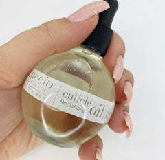 Cuccio Naturale Revitalizing Cuticle Oil on nails supports stronger, healthier-looking growth.