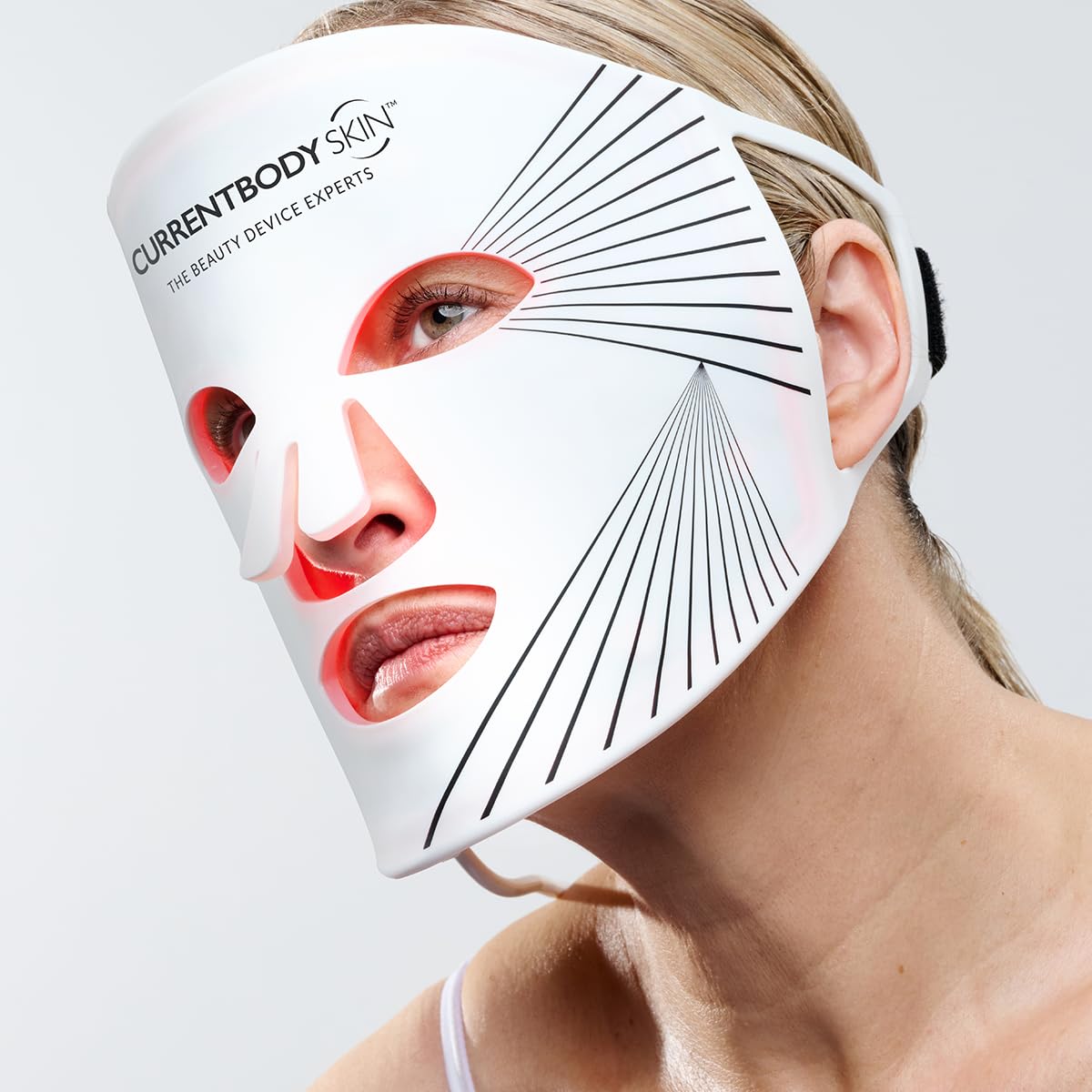 CurrentBody light therapy mask on the face delivering red and near-IR light.