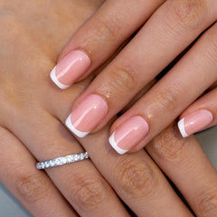 Curvlife French-tip nails on hand demonstrate salon-quality sparkle and quick wear.