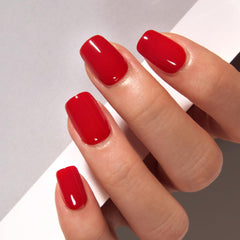 CurvLife clear red oval nails close-up, glossy finish for natural, seamless look.