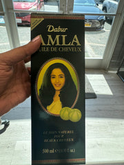 Dabur Amla Hair Oil close-up shows amla extract for scalp nourishment.
