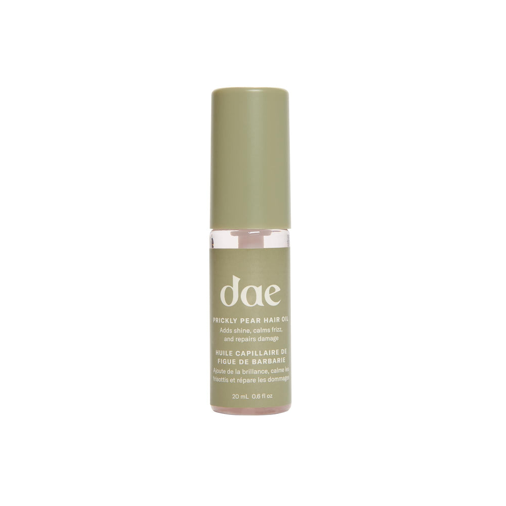 DAE Prickly Pear Hair Oil bottle pouring for smooth frizz control and shine.