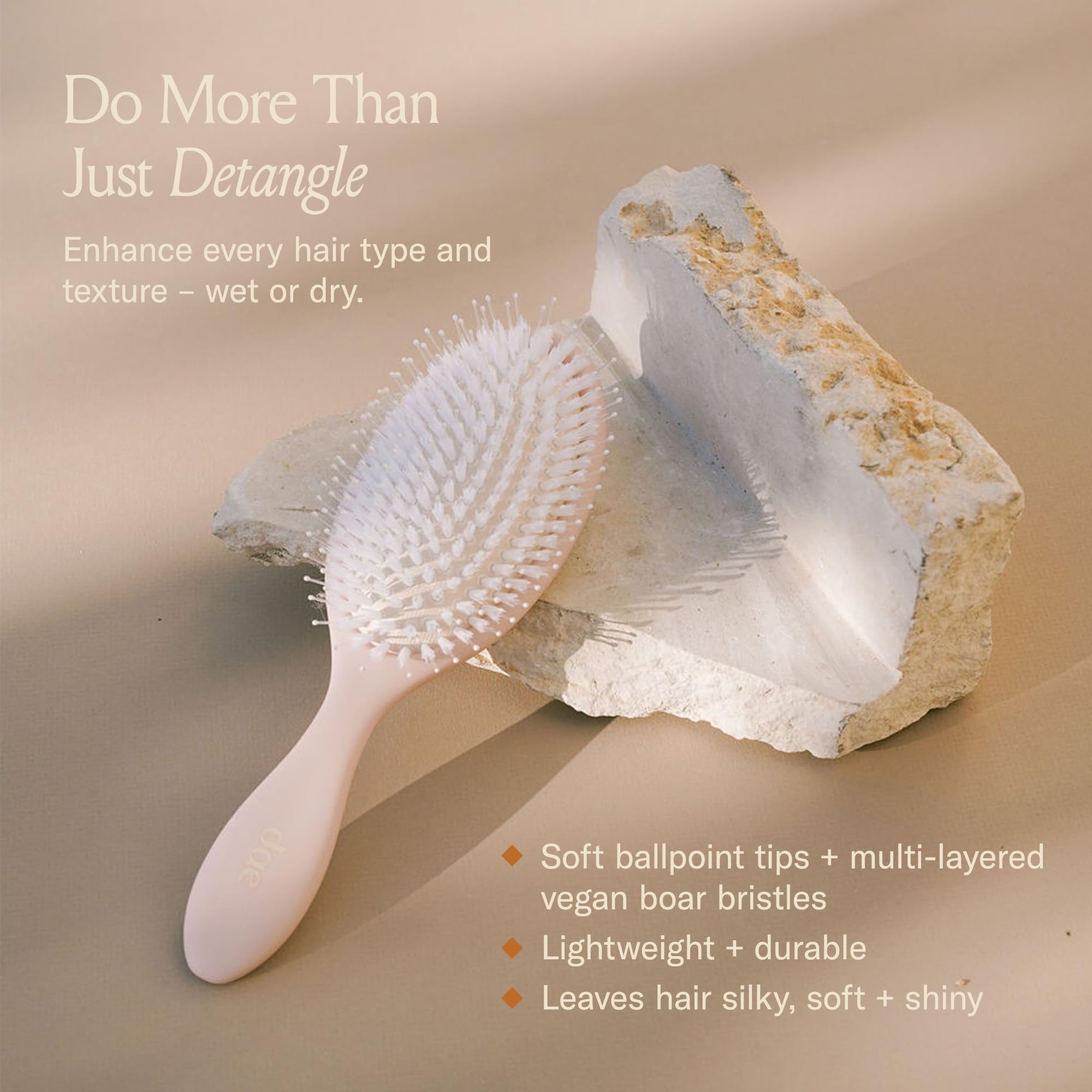 DAE Vegan Detangle + Style Brush in action detangles hair with nylon and smoothing vegan bristles.