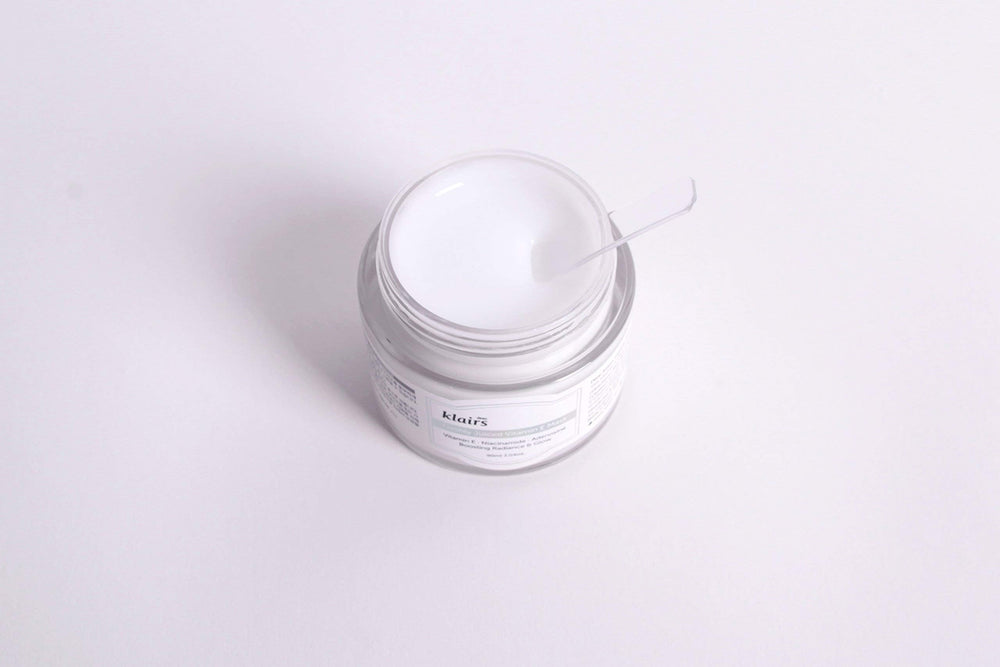 Application shot of DearKlairs mask showing dual-use as day moisturizer and overnight mask.