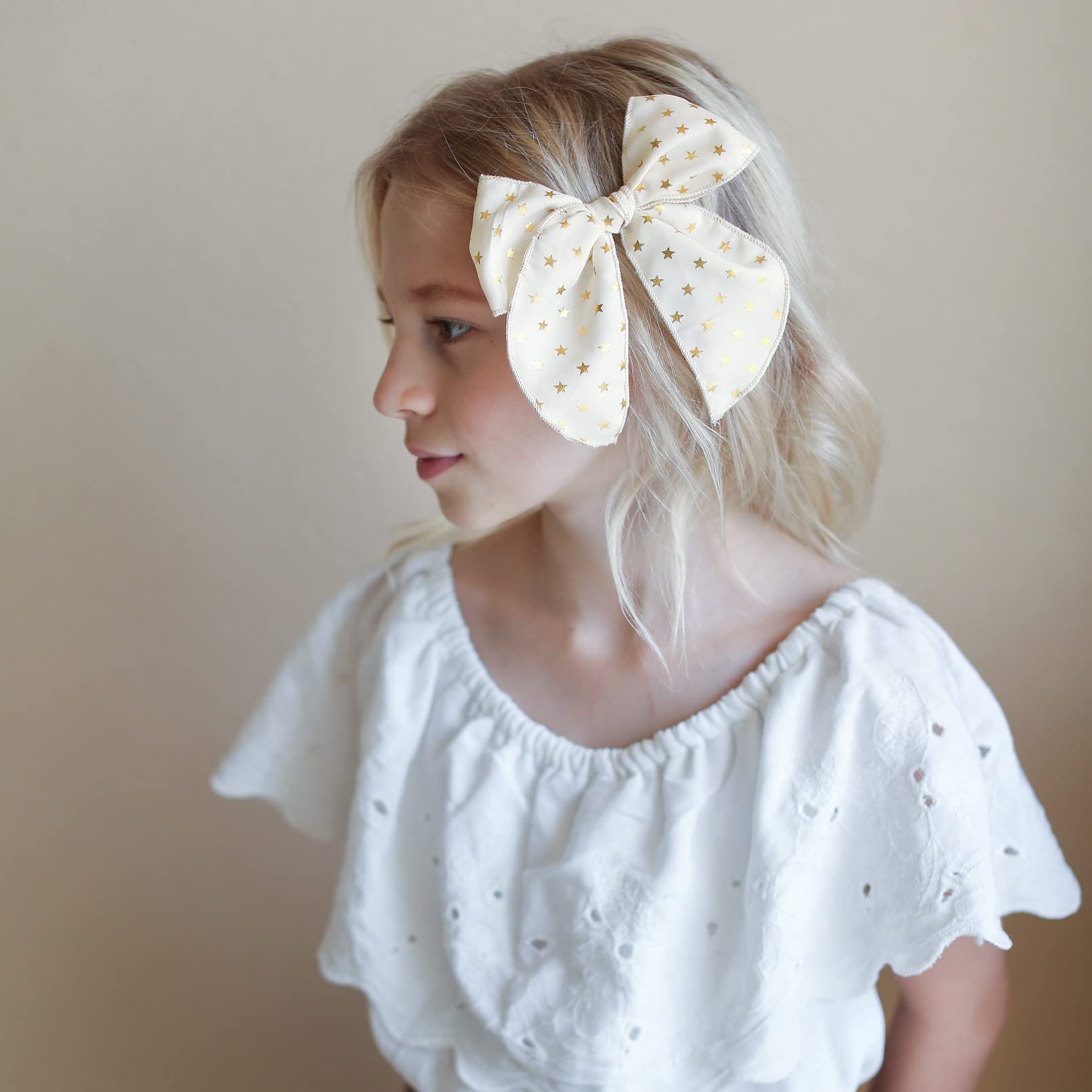 DEEKA beige star pattern bow clip with subtle shine for versatile holiday style