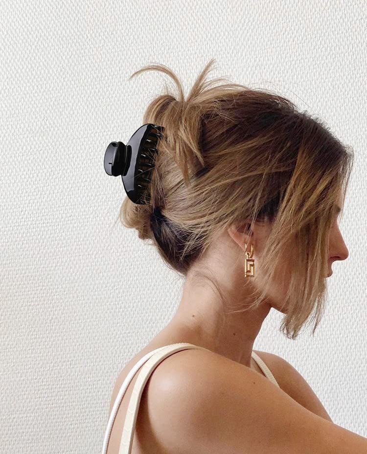 DEEKA clip holding a half bun in styled hair