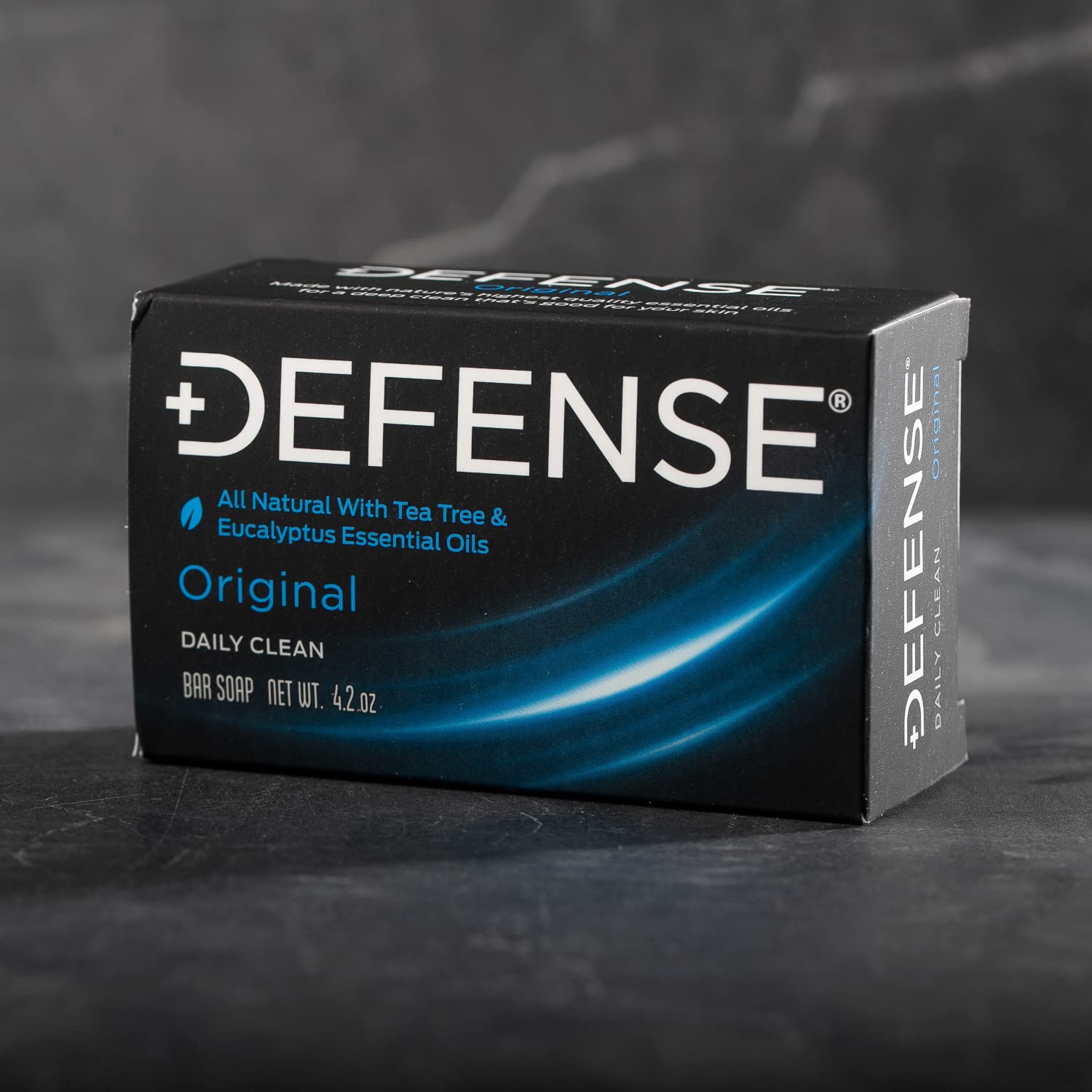 Defense Soap tea tree bar stacked on shower shelf for athletes' daily cleansing.