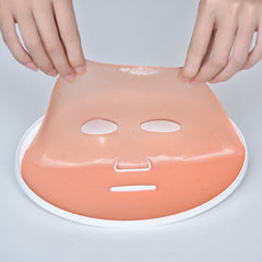 DeMoce Face Mask Maker device pouring fruit essence into the mixer for a fresh mask.