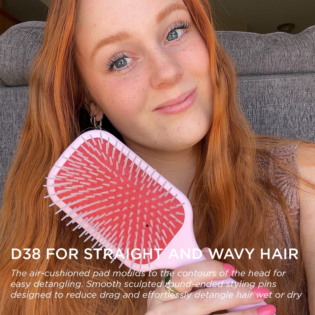 Denman D38 pink paddle brush on head demonstrating wide paddle coverage