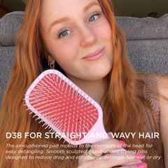 Denman D38 pink paddle brush on head demonstrating wide paddle coverage
