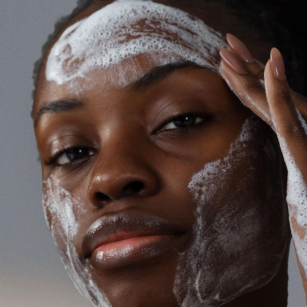 Dermalogica Clear and Brighten Kit serum dropper applying on cheek glow.