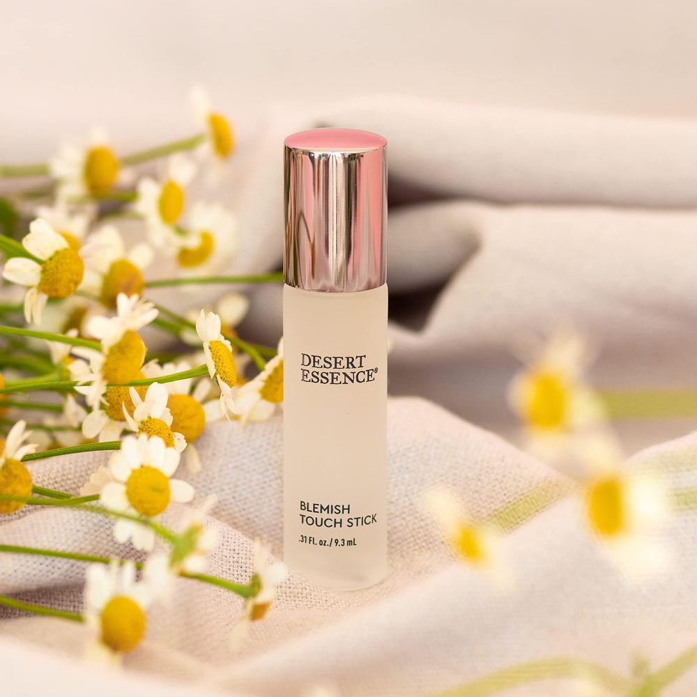 Desert Essence blemish-stick on skin; soft-focus, gentle blemish care.