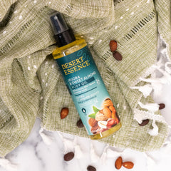 Desert Essence body oil spray mist gliding over skin for quick absorption