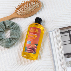 Desert Essence Jojoba Oil bottle pour—quick-absorbing moisture for face and body.