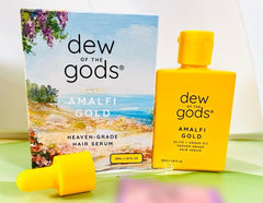 Dew Of The Gods Amalfi Gold Hair Serum bottle promoting frizz control and nourishment.