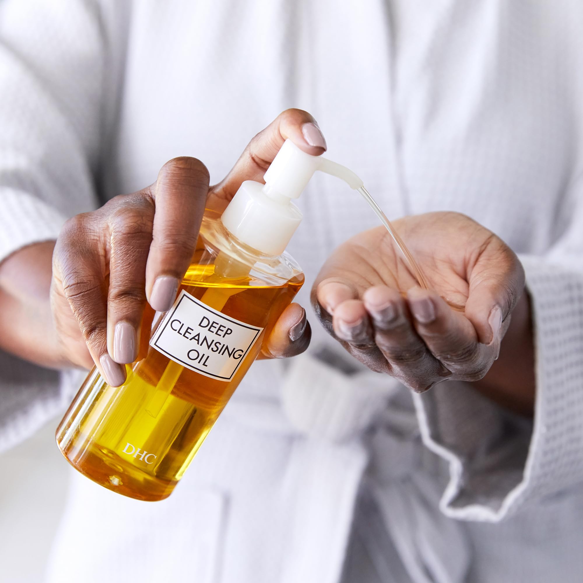 DHC Deep Cleansing Oil makeup-removal action highlights mascara and eyeliner removal.