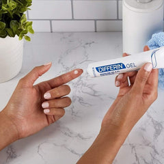 Differin Adapalene Gel swatch on hand suggests quick absorption and usage.
