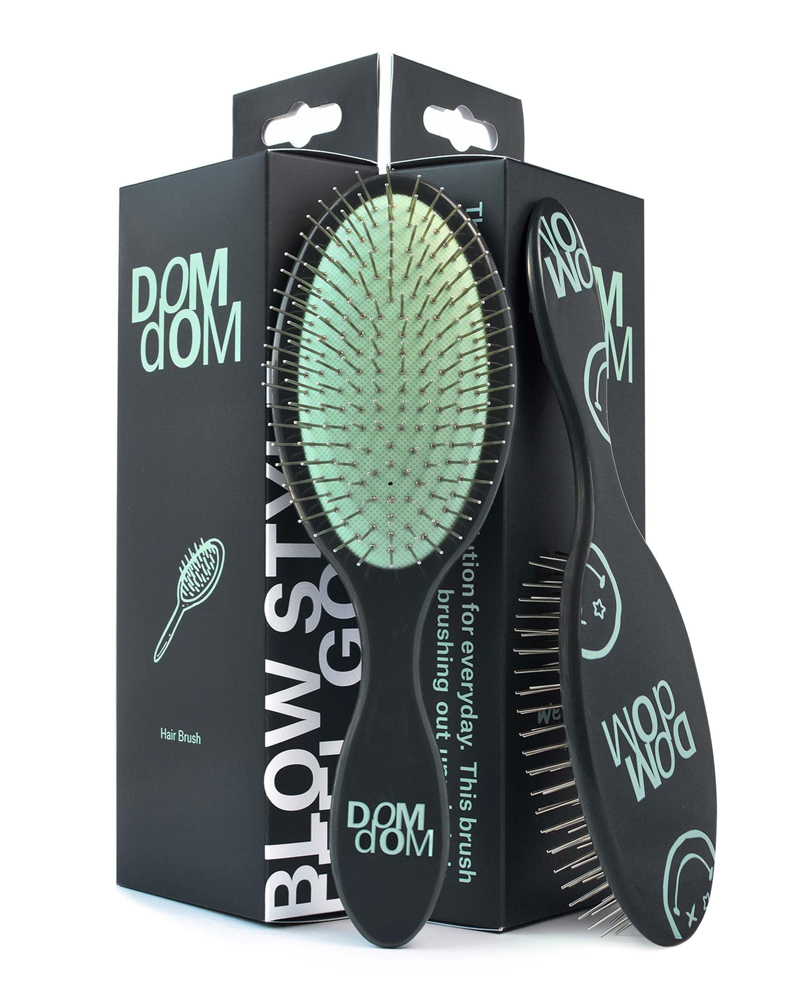 Dom Dom detangling brush in shower with drainage hole for fast drying.