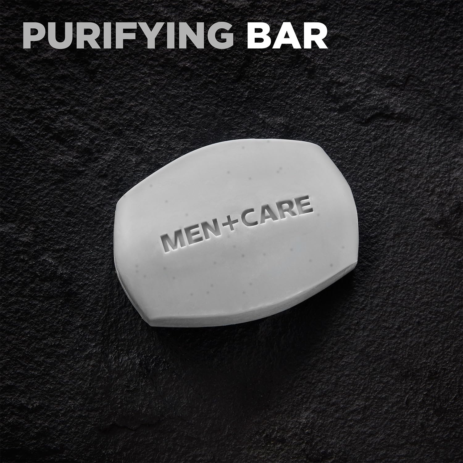 Dove Men+Care Bar charcoal close-up shows exfoliation and clay cleanse.
